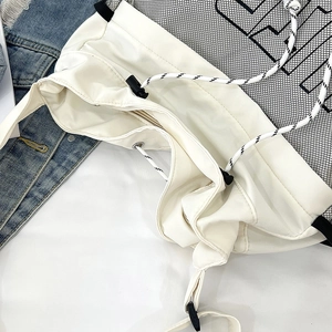 Detail of drawstring mesh backpack with logo print and adjustable toggle closure