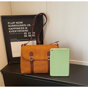 Maillard style retro suede messenger bag shown next to a green tablet for size reference
