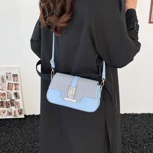 Modern light blue square crossbody bag with grey woven texture flap and gold clasp