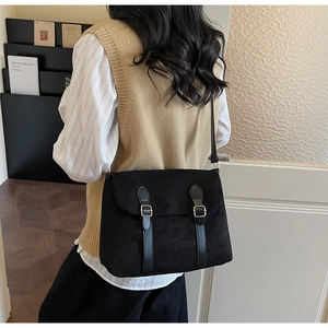 Retro black matte suede underarm bag shown in a professional lifestyle library setting