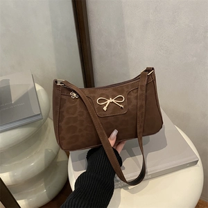 Dark brown leopard pattern underarm bag with a stylish golden bow metallic accessory