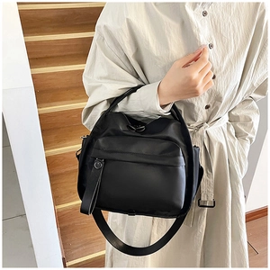 Detail showing high-density black nylon fabric and durable horizontal zipper pocket of the bag