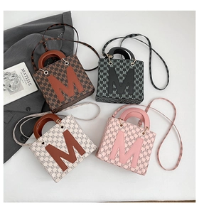 Detailed display of four color mini square bags featuring letter M prints and top handles