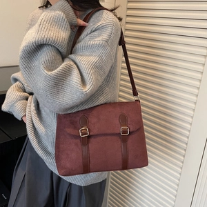 Vintage reddish-brown suede messenger bag with leather straps and gold metal buckle
