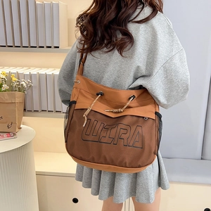 Brown canvas crossbody bag with mesh pocket and WIRA print in stylish casual street style