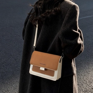Trendy tricolor crossbody bag in brown and cream with Fashion & Bags text on the flap