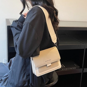 Chic beige crossbody square bag with wide shoulder strap and minimal leather design