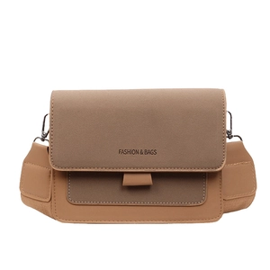 Retro two-tone crossbody bag with khaki suede flap and fashion lettering on white background