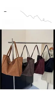 Detailed display of four vintage matte leather tote bags in brown, coffee, red, and black