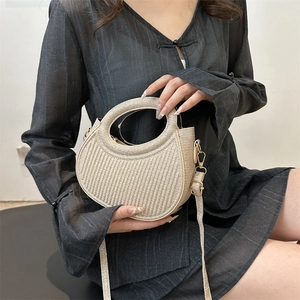 Minimalist beige woven crossbody handbag with a circular handle and wave texture