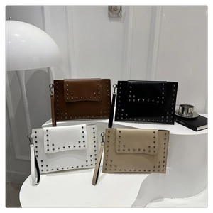 Detailed arrangement of stylish rivet clutch bags in brown, black, white, and beige colors