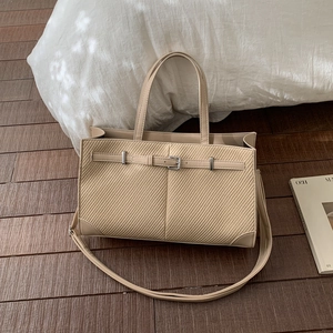 Beige woven texture tote bag with buckle detail and adjustable shoulder strap