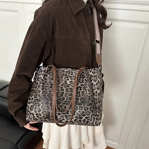 Leopard print tote bag with geometric patterned shoulder strap and leather handles