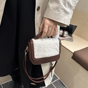 Minimalist brown faux leather crossbody bag with white sherpa flap and gold hardware