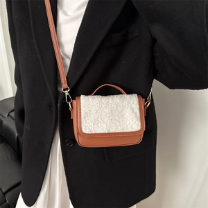 Chic brown faux leather and white shearling mini crossbody bag with gold hardware detail