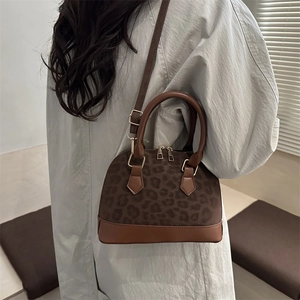 Leopard print shell handbag with leather trim and adjustable shoulder strap for women