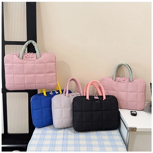 Detailed view of quilted waterproof document bags in pink, navy, gray, and black finishes