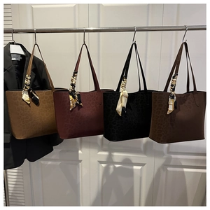 Detail view of leopard pattern tote bags in four colors with decorative silk scarves