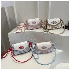 Detail of colorful mini crossbody bags with polka dots and handmade apple patches