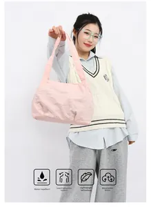Pink pleated bucket bag showing water-repellent fabric and lightweight shoulder design