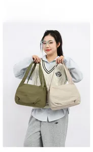 Detail showing olive green and beige large nylon tote bags with pleated texture