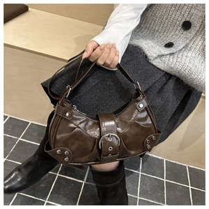 Detailed shot of dark brown PU leather shoulder bag featuring vintage silver studs