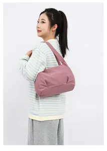 Detail shot of dusty pink minimalist bucket bag with natural pleated design on shoulder