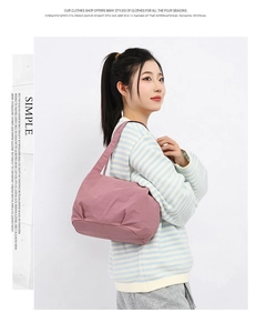Fashionable mauve nylon bucket tote bag styled with a casual striped sweater and trousers