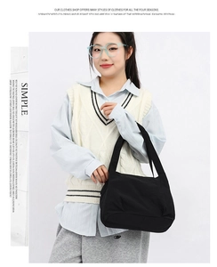 Minimalist black bucket bag shown with a modern casual outfit for daily styling