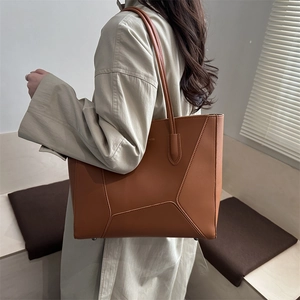 Chic brown leather tote bag with geometric stitching for stylish daily commuting use