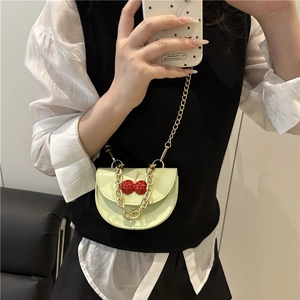 Mint green semi-circle crossbody bag with red cherry charm and gold chain strap for women
