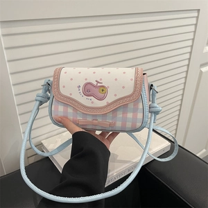 Detail of pink and blue checkered bag with cherry embroidery and bow decoration