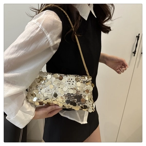 Close-up of golden and silver sequins on a minimalist evening shoulder bag