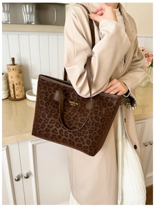 Macro detail of brown leopard print tote bag with New York lettering on soft texture