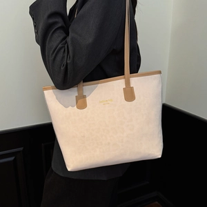 Fashionable off-white tote bag with leopard trim and gold New York text detail
