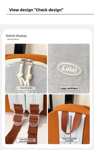 Detail of color-block backpack with Lolo logo, dual zippers and adjustable straps