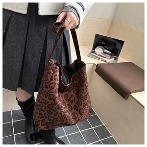 Macro detail of the leopard print faux suede fabric on a large shoulder tote bag