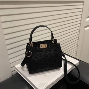 Chic leopard print handbag in dark black suede finish with elegant golden hardware