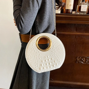 White croc-effect round shoulder bag with gold metal circular handle and chain strap