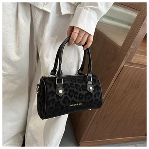 Detail of leopard print boston bag with gold lettering and sturdy dual top handles