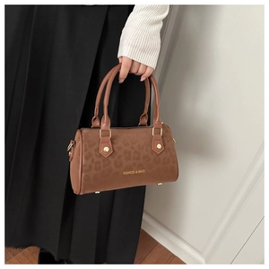 Detail of leopard print handbag showing metal buckle and 'FASHION & BAGS' text logo