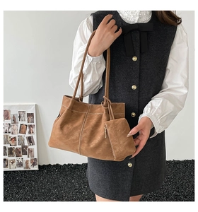 Detailed view of the brown suede tote bag set with matching small zipper pouch and stitching