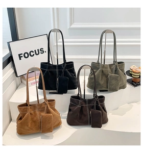 Detail of suede tote bags in four colors with contrast stitching and small pouches