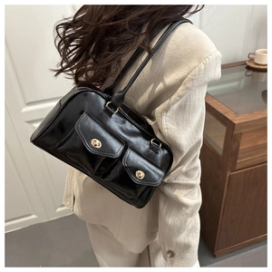 Detail of vintage oil wax leather shoulder bag featuring double front flap pockets