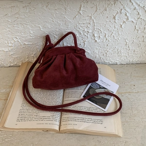Fashionable burgundy suede cloud bag with pleated drawstring and thin crossbody strap