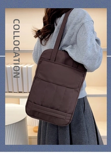 Close-up of a stylish dark brown tote bag featuring a front flap pocket and quilted detail
