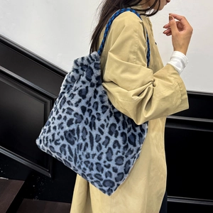 Furry leopard print tote bag with woven handles shown from a 45-degree angle