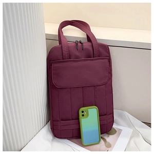 Macro detail of wine red laptop tote bag showing vertical stitching and front pocket flap