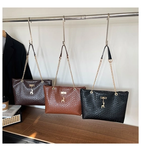 Detailed woven shoulder bags with gold chain straps and deer charms in three colors