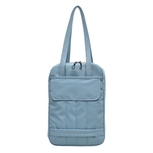 Light blue minimalist tote bag with front flap pocket and vertical quilted details